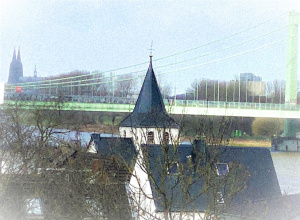 Kirche Alt Sankt Maternus in Rodenkirchen mit Blick zum Kölner Dom und Rhein.